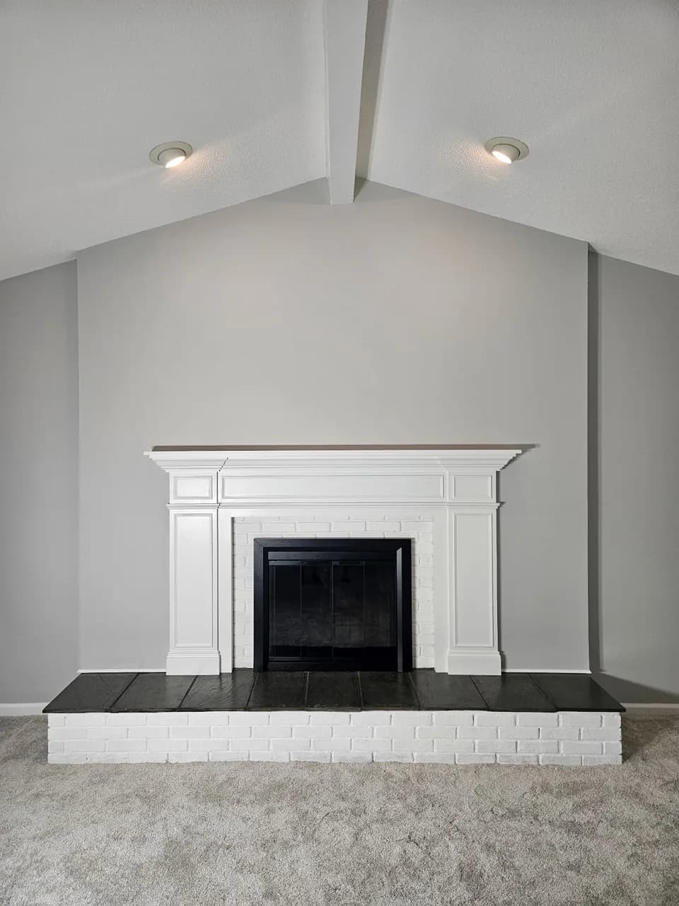White fireplace mantel against a gray painted wall, shared by Erin Klotz on Entryways’ Google Maps listing.